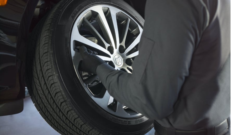 Buick Protection Service Expert Checking Tire