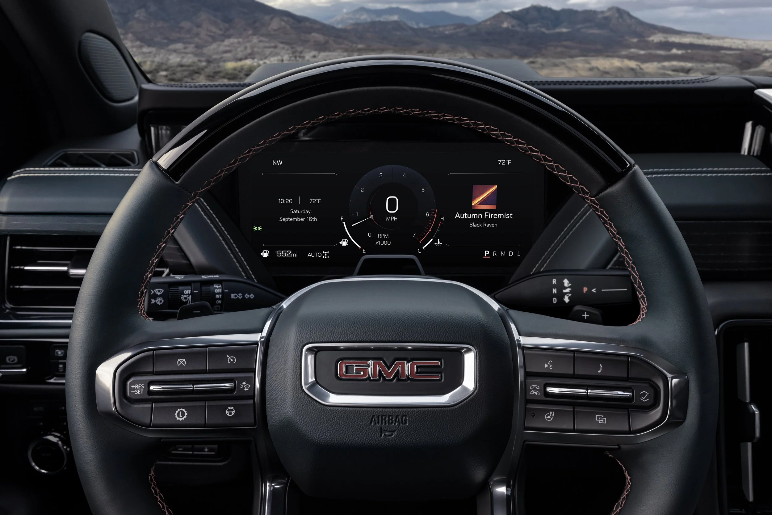 GMC steering wheel and digital driver display interior detail showing speedometer and trim colors
